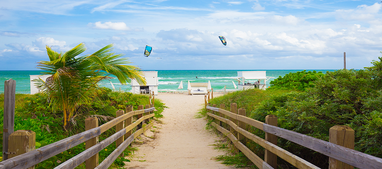 This is a stock photo. A pathway to the beach on Miami Beach, Florida.